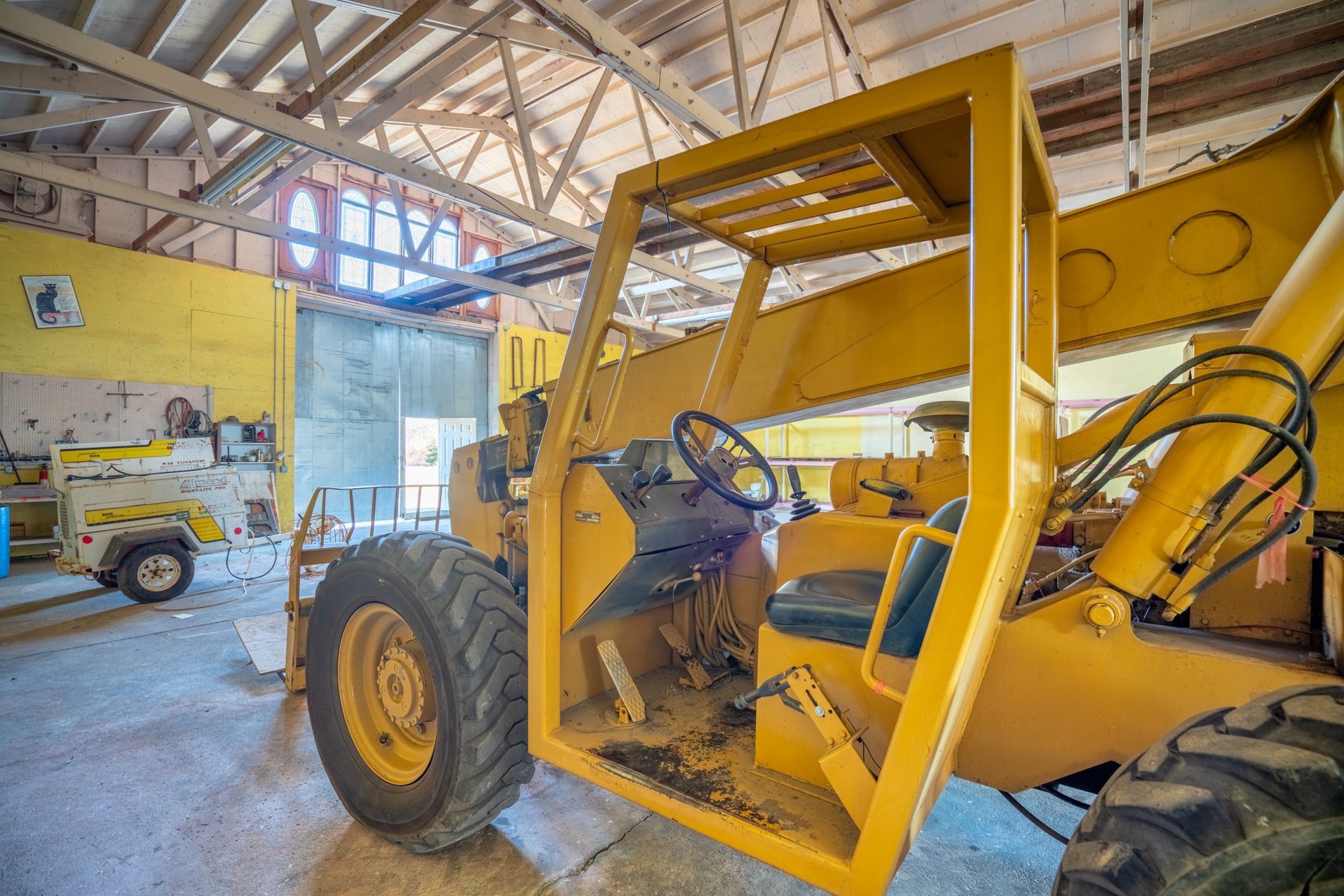 The storage barn interior with heavy equipment, showing the scale of the space